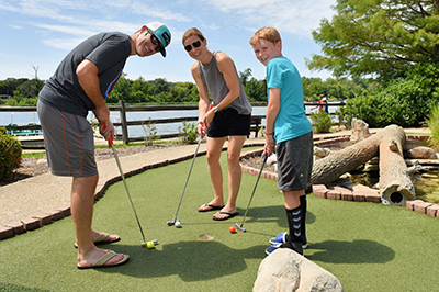 Family playing minigolf